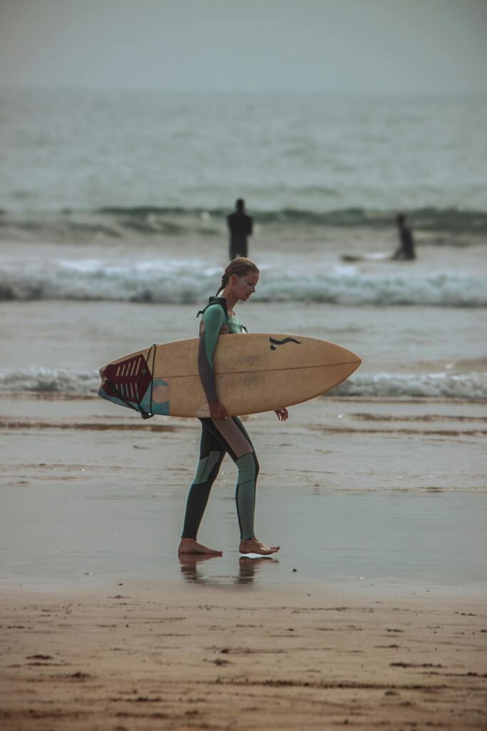 female surfer Taghazout beach Agadir Morocco surf lesson Atlantic coast