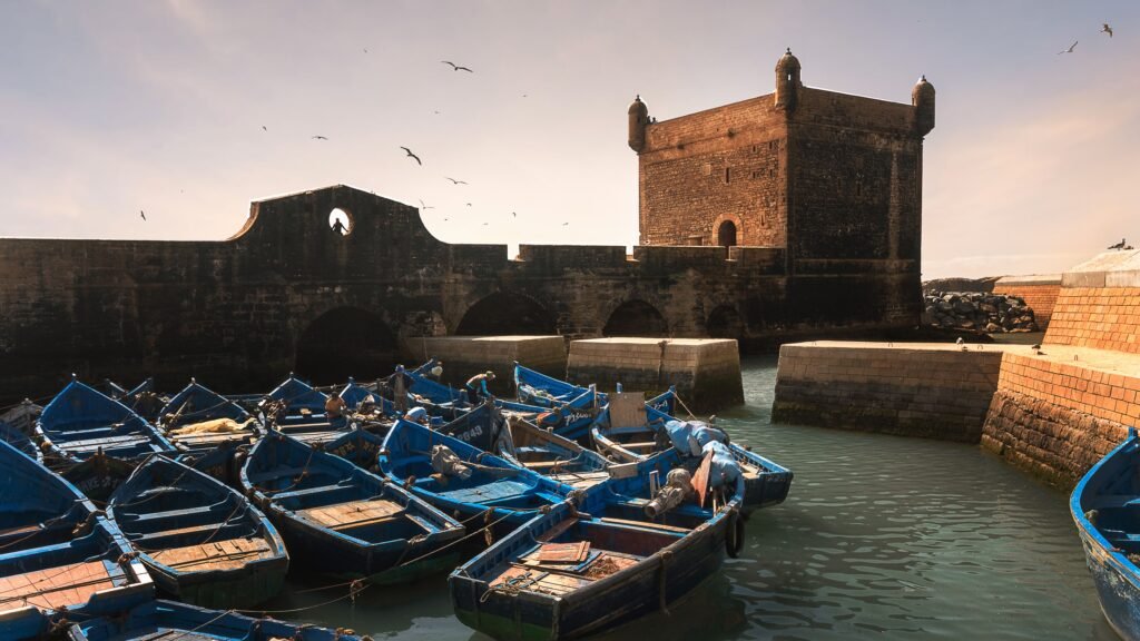 Essaouira Day Trip from Marrakech: The Complete 2026 Guide Essaouira blue fishing boats harbor Skala du Port day trip from Marrakech Morocco