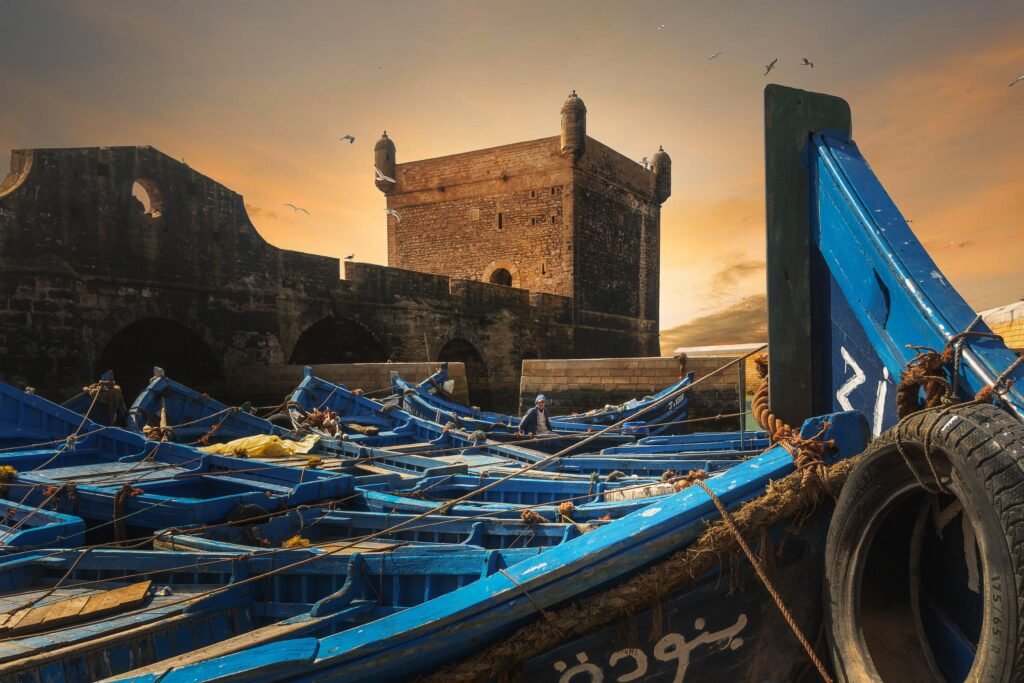 Essaouira Day Trip from Marrakech: The Complete 2026 Guide Skala du Port Essaouira sunset blue fishing boats day trip from Marrakech Morocco